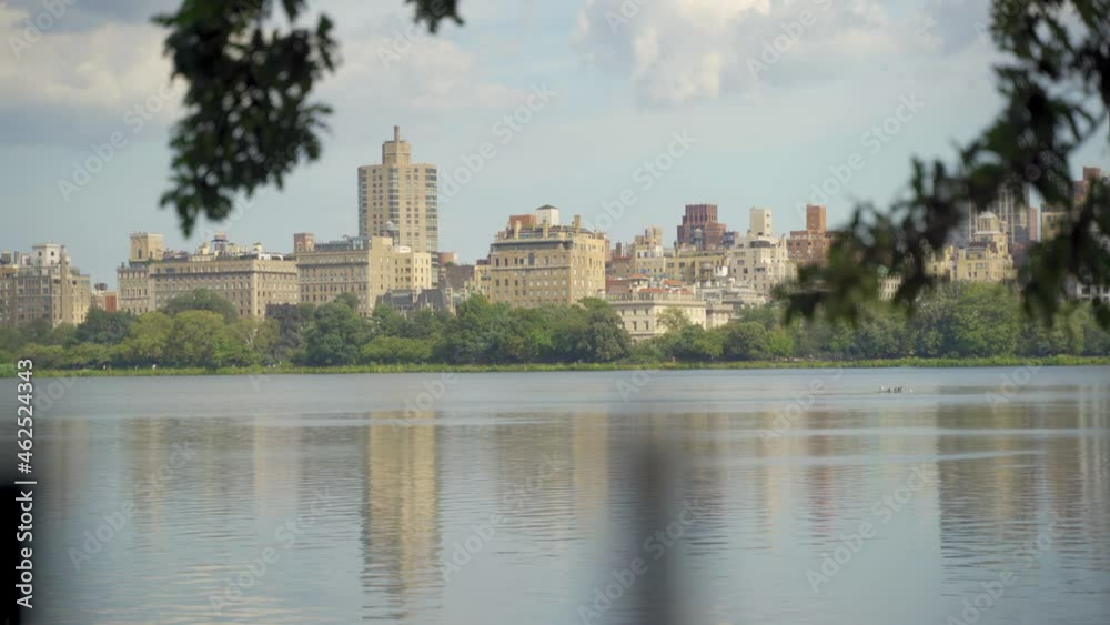New York City Manhattan Central Park panorama in Autumn lake with skyscrapers and colorful trees over with reflection. New York City Manhattan Central Park panorama in Autumn lake with skyscrapers and colorful trees over with reflection.
