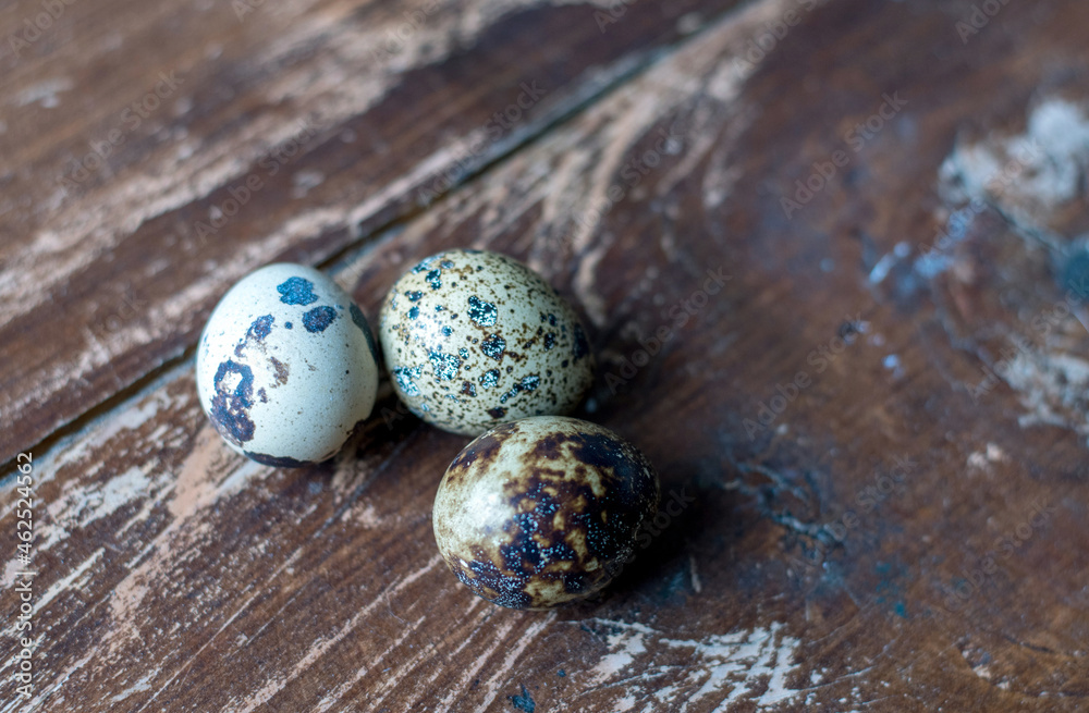Obraz premium close up of tiny quail eggs on a rustic wood table