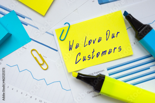 Financial concept meaning We Love Our Customers with inscription on the piece of paper.