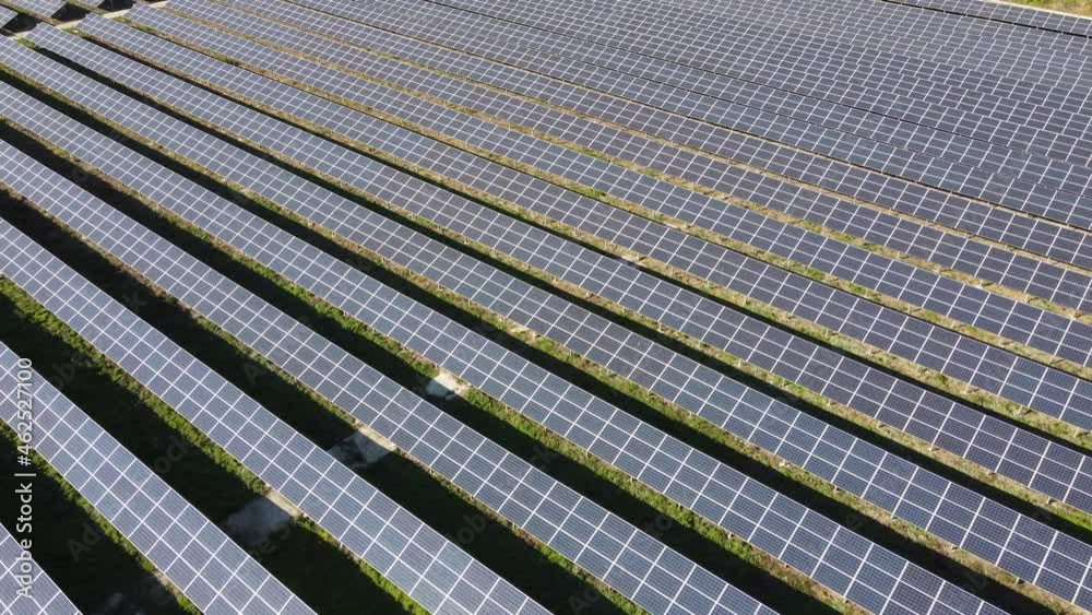 Aerial video from a height close up of solar panels at a solar power plant. Solar farm that produces clean energy, green tariff Aerial video from a height close up of solar panels at a solar power plant. Solar farm that produces clean energy, green tariff