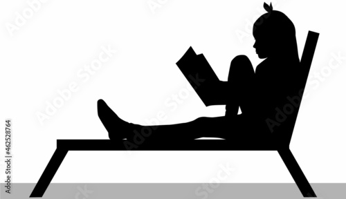 Silhouette of a girl reading a book.