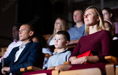 Family with son watching spectacle in the theater