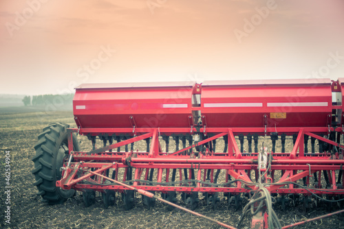Red seeder left in the field in spring, autumn. photo