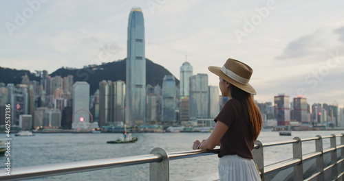 Woman look at the Hong Kong city at sunset time