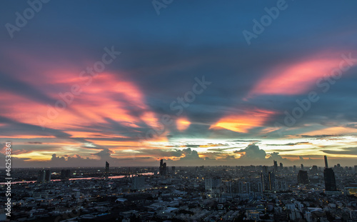 Bangkok, thailand -Sep 17, 2021 : Fantastic colorful sunset sky over the bangkok city skyscrapers with bright glowing lights at dusk give the city a modern style. Copy space, Selective focus.