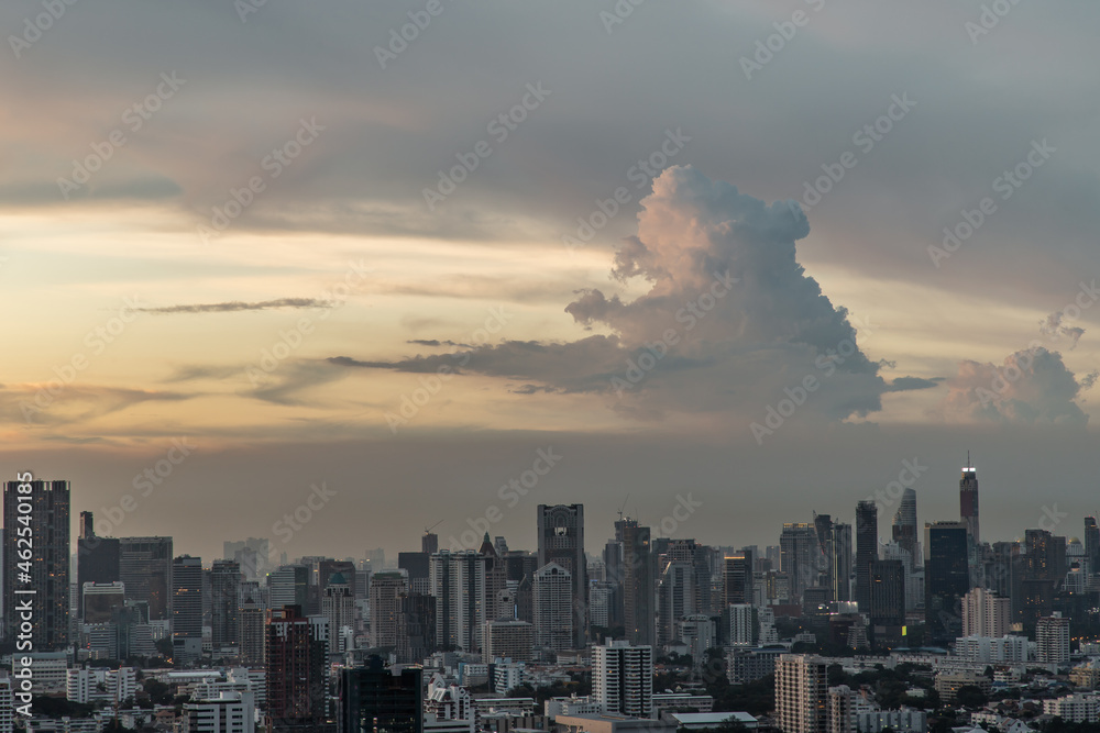 Fototapeta premium Bangkok, Thailand - Aug 23, 2021 : Aerial view of Beautiful sunset over large metropol city in Asia. With tall building and skyscraper in background. Monotone, No focus, specifically.
