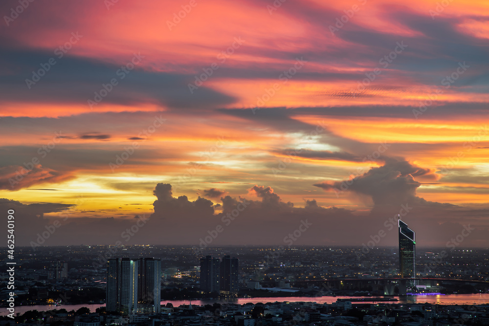 Fantastic colorful sunset sky over the bangkok city skyscrapers and the Bridge crosses the Chao Phraya river with bright glowing lights at dusk give the city a modern style. Copy space.