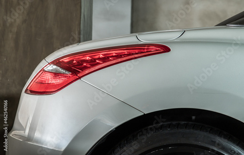 Bangkok, Thailand - 31 Aug 2021 : Close-up of Rear light or Tail lamp of White peugeot rcz sports car parked in the parking lot. Selective focus. photo