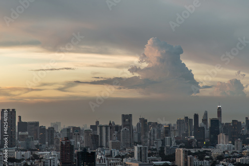 Bangkok, Thailand - Aug 23, 2021 : Aerial view of Beautiful sunset over large metropol city in Asia. With tall building and skyscraper in background. Monotone, No focus, specifically. © num