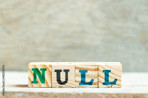 Alphabet letter block in word null on wood background
