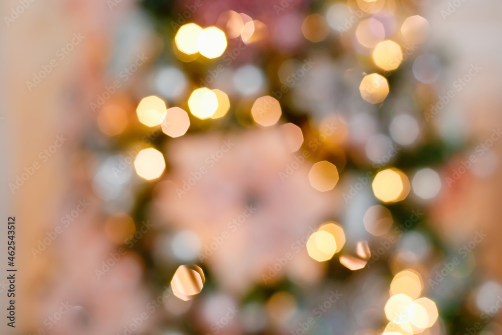 Abstract background blurred Christmas tree with bokeh lights with pink decorations. Abstract background blurred Christmas tree with bokeh lights with pink decorations.
