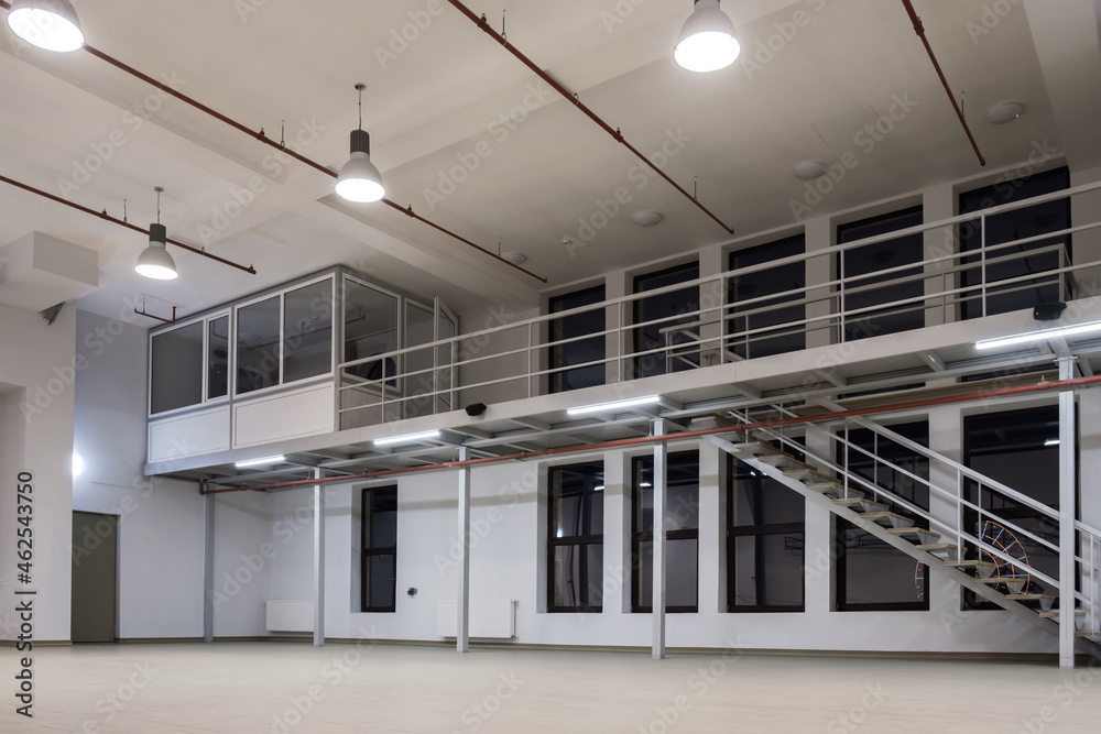 Interior of a large industrial space with mezzanine at night - obrazy, fototapety, plakaty 