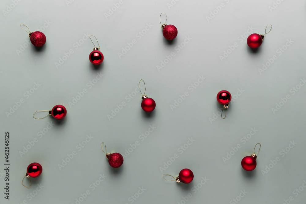 Pattern on gray background with small red Christmas balls, sphere fir tree toys Pattern on gray background with small red Christmas balls, sphere fir tree toys