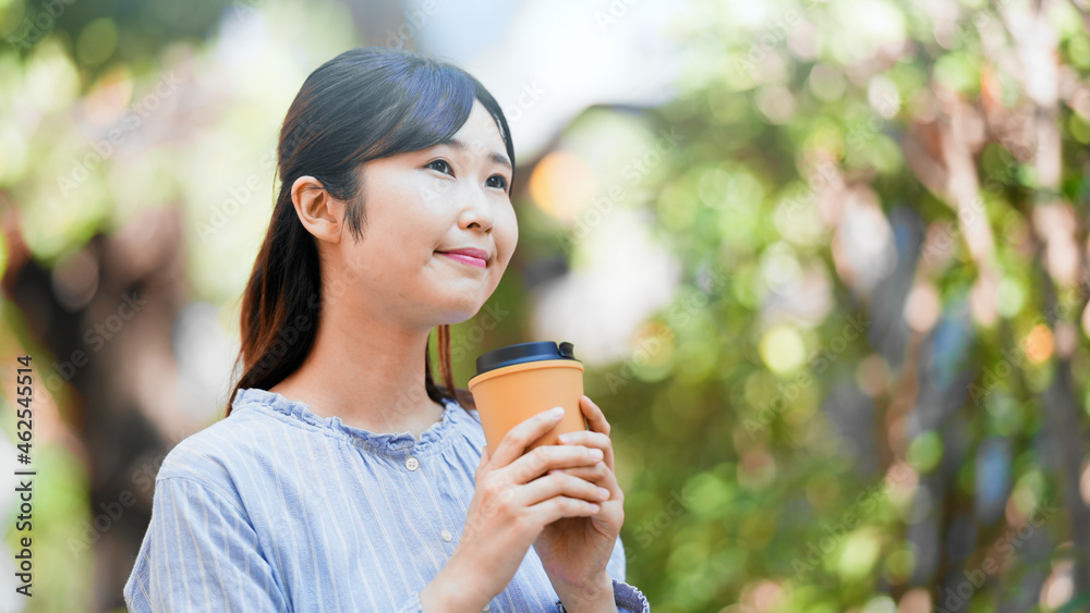 ドリンクカップを持つ女性