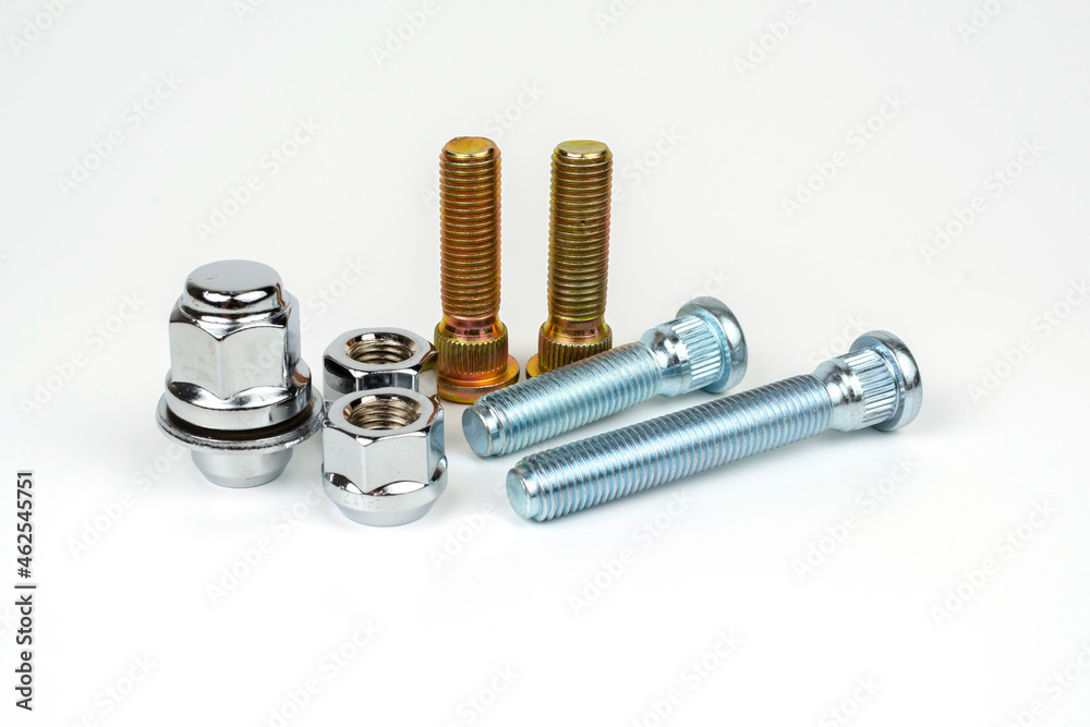 metal stud and shiny car wheel nuts close-up on a white background. car spare part