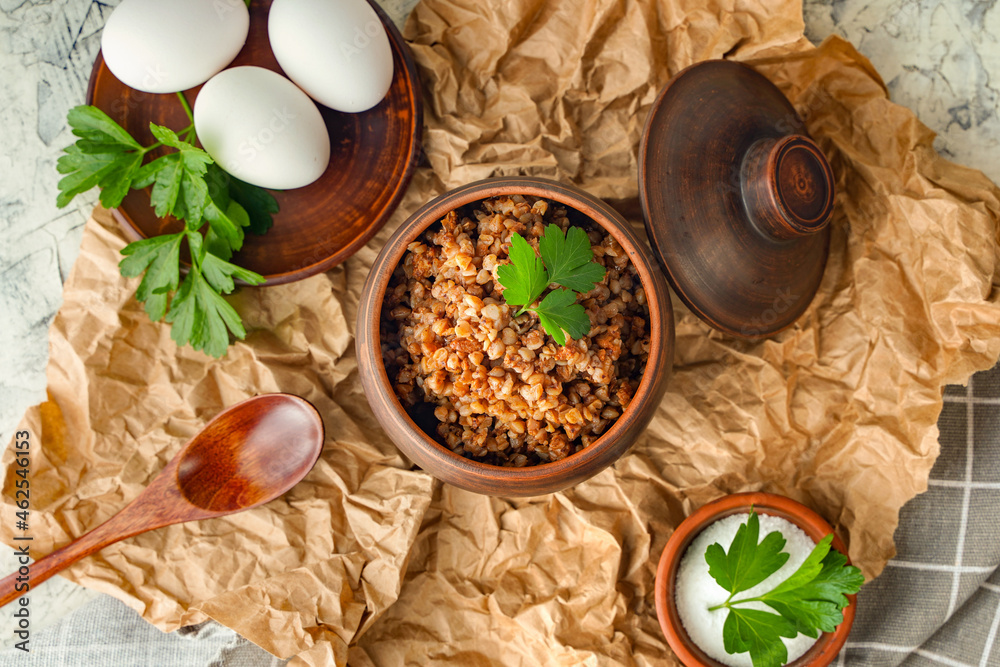 A pot of buckwheat porridge and boiled eggs. Balanced nutrition, anti-crisis food. Diet healthy lunch or lunch. Rustic style