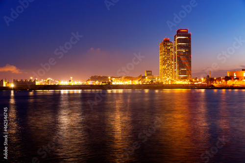 Urban landscape of Barcelona with view of Olympic Harbour and twin towers in evening time.