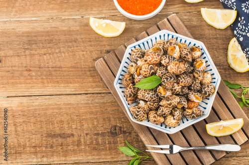 Babylonia areolata shellfish seafood on bowl ready for eat or cooked photo