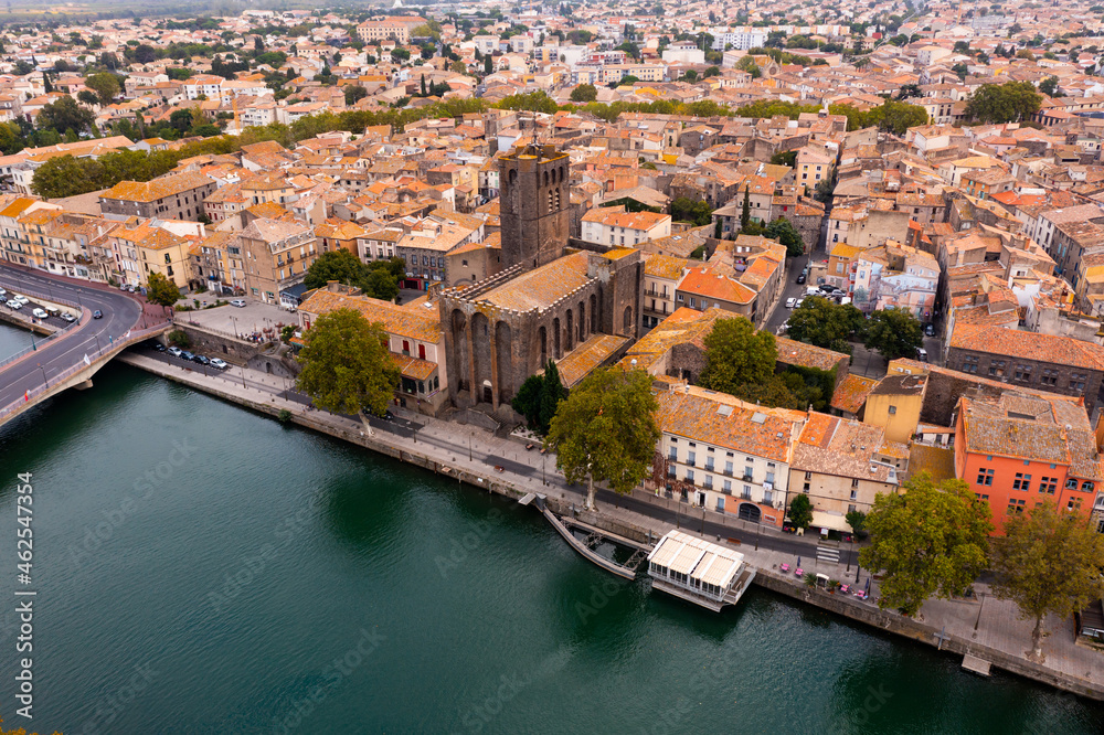 Bird's eye view of Agde, southern France. Residential buildings and Herault River visible from above.