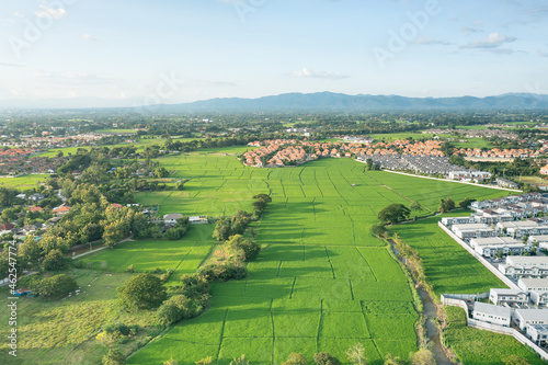 Land or landscape of green field in aerial view. Include agriculture farm, house building, village. That real estate or property. Plot of land for housing subdivision, development, sale or investment.