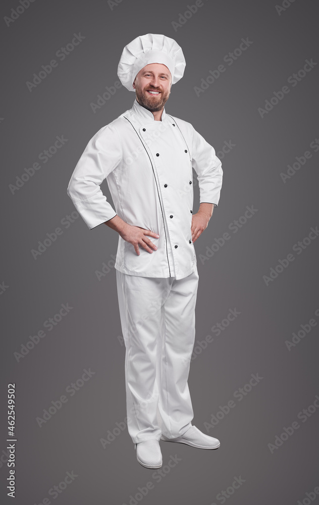 Confident chef in uniform on gray background Confident chef in uniform on gray background