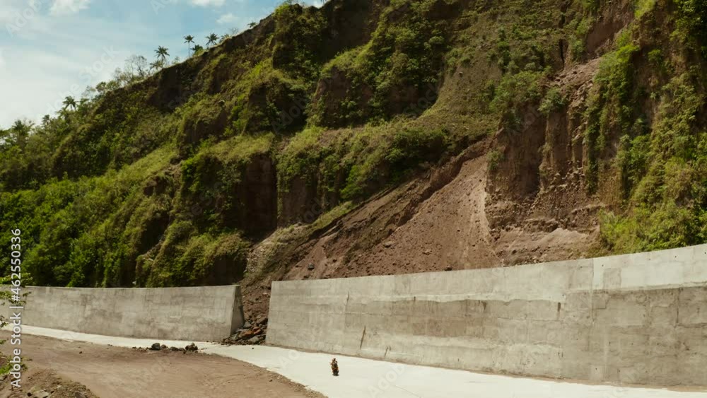 Landslides and rockfalls on the road in the mountains.Aerial view: mud and rocks blocking the road.Destroyed rural road landslide damaged in powerful flood. Collapsed on the mountain. Philippines