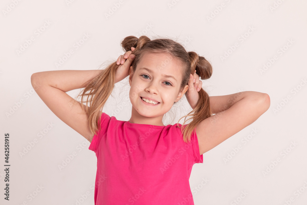 happy child on a white background. a girl in a pink T-shirt and pants. happy child on a white background. a girl in a pink T-shirt and pants.