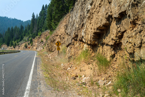 Rocky cliffs line the side of a curving road in southeastern Idaho, USA