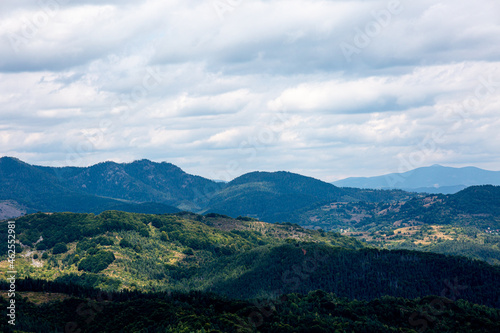 View to mountain and forest with cloudy sky