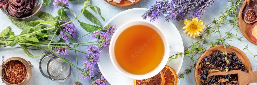 Tea panorama with herbs, flowers and fruit, an overhead flat lay shot. Healthy hot drink panoramic banner with lavender Tea panorama with herbs, flowers and fruit, an overhead flat lay shot. Healthy hot drink panoramic banner with lavender