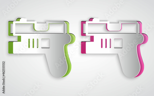 Paper cut Futuristic space gun blaster icon isolated on grey background. Laser Handgun. Alien Weapon. Paper art style. Vector