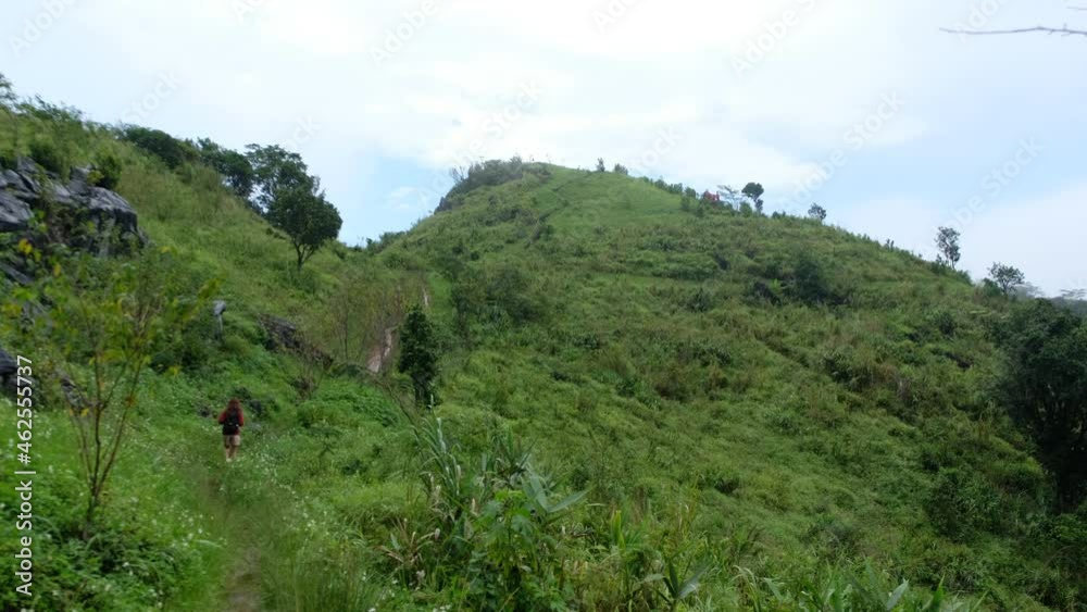 A female traveler hiking at a beautiful mountains A female traveler hiking at a beautiful mountains