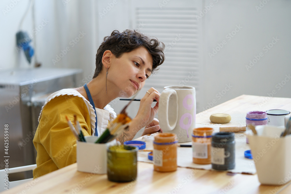 Young woman spend time in ceramic studio working on pottery relaxed and happy enjoy art classes and artistic creative entertainment. Small business owner lady entrepreneur creating potter earthenware Young woman spend time in ceramic studio working on pottery relaxed and happy enjoy art classes and artistic creative entertainment. Small business owner lady entrepreneur creating potter earthenware