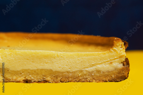 Fresh round bright orange homemade cheesecake on a bright background. promotional offer, texture pie close-up. a place to copy. banner advertising. large format. etymology of taste