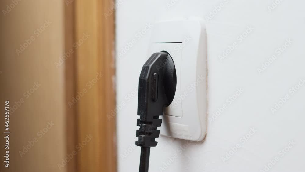 The hand inserts the plug into the socket. Close-up. Circuit. The hand inserts the plug into the socket. Close-up. Circuit.