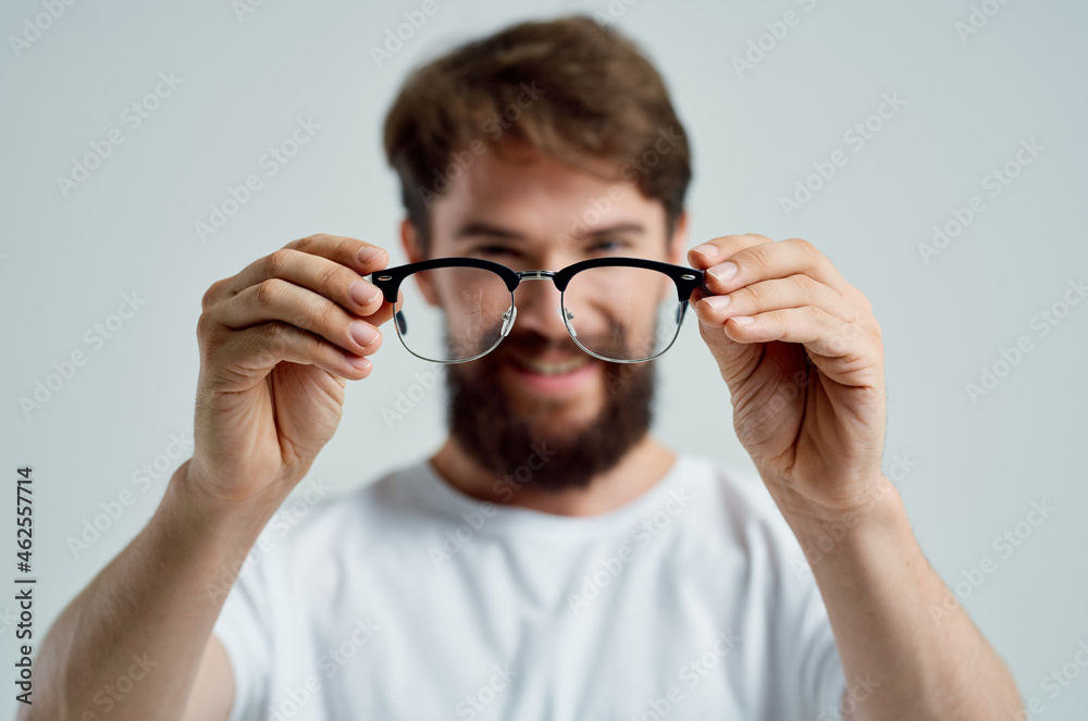 bearded man vision problems in white t-shirt light background