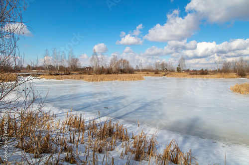 Frozen lake in winter and blue sky