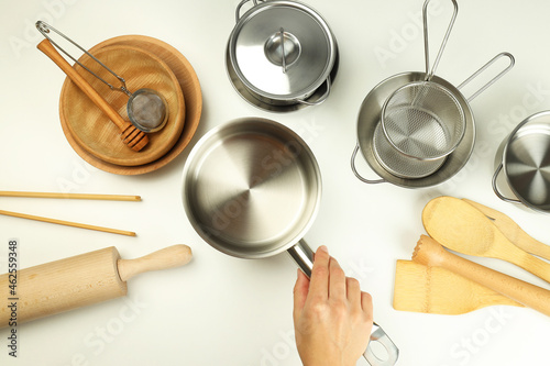 Composition with kitchen utensil on white background, top view