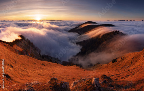 Foto Colorfull sunset behind Mountain peak landscape above clouds - panorama