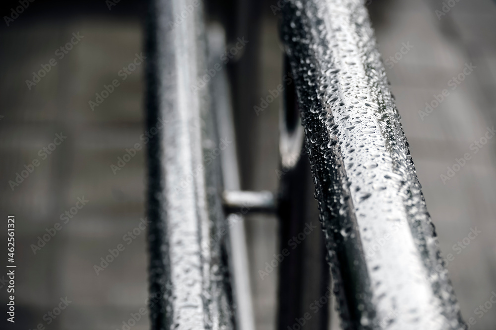 Background with wet metal chrome railings covered with raindrops. Abstract background. The concept of safety of people with disabilities. Weather conditions. Background with wet metal chrome railings covered with raindrops. Abstract background. The concept of safety of people with disabilities. Weather conditions.