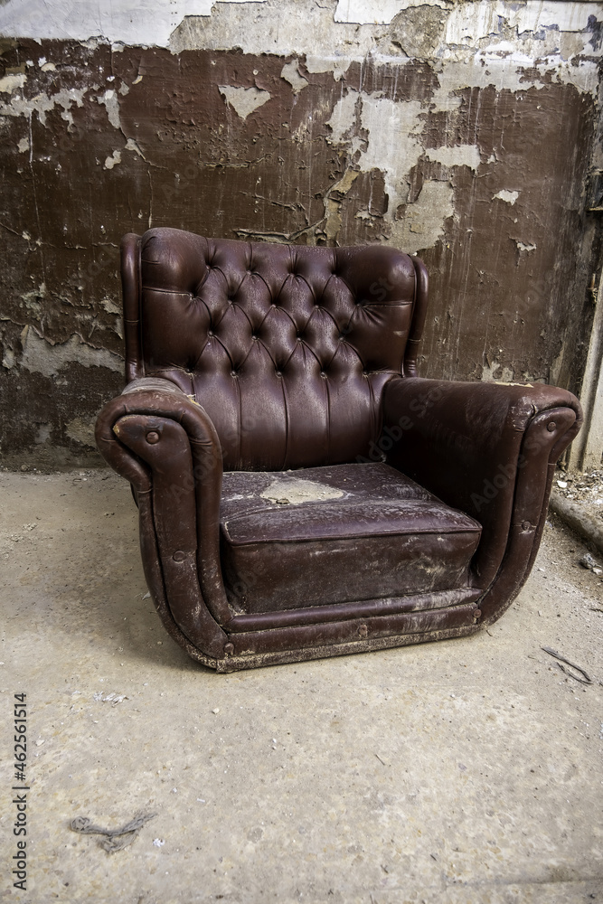 Old abandoned leather armchair