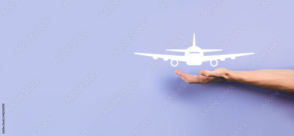 Male hand holding plane airplane icon on blue background. Banner.nline ticket purchase.Travel icons about travel planning, transportation, hotel, flight and passport.Flight ticket booking concept. Male hand holding plane airplane icon on blue background. Banner.nline ticket purchase.Travel icons about travel planning, transportation, hotel, flight and passport.Flight ticket booking concept.