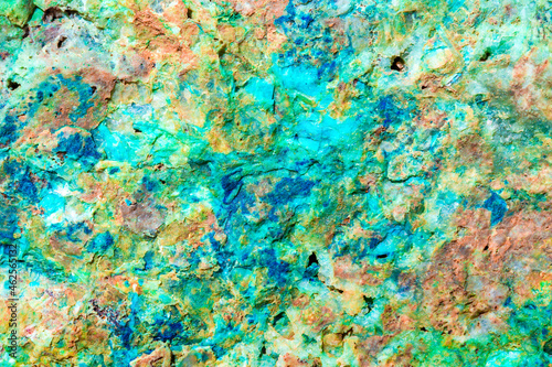 Background from dracocene crystals of stones. Fluorite stone in the rocks of the adit. Mineral stones in their natural environment. Semiprecious stones texture.