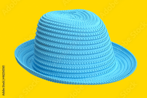 Vintage blue straw beach sun hat isolated on yellow and sun protection