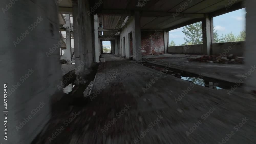 FPV drone flies fast through an abandoned building. Post-apocalyptic location without people FPV drone flies fast through an abandoned building. Post-apocalyptic location without people
