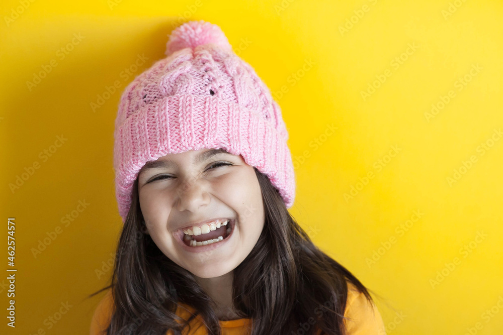 Happy beautiful smiling child girl in knitted hat. Space for text. Autumn consept. Happy beautiful smiling child girl in knitted hat. Space for text. Autumn consept.