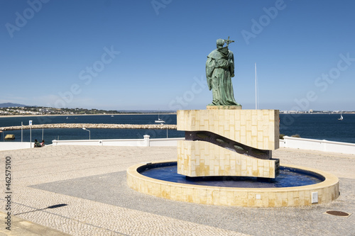 Statue of Gundisalvus and Traditional style Portuguese Calcada Pavement for pedestrian area in Lagos, Algarve, Portugal