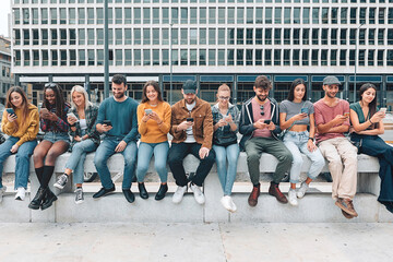 group of young people in city using mobile phone sitting on street - z gen youth absorbed by social network - lifestyle technology concept - boys and girls connected to the net