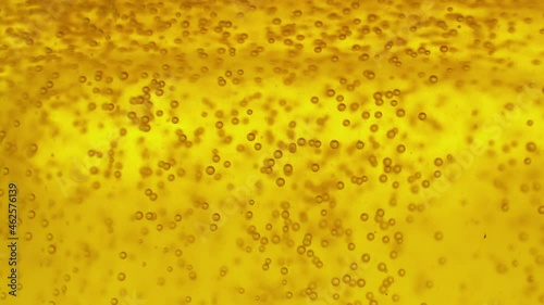 Glowing light golden ale with effervescence background texture