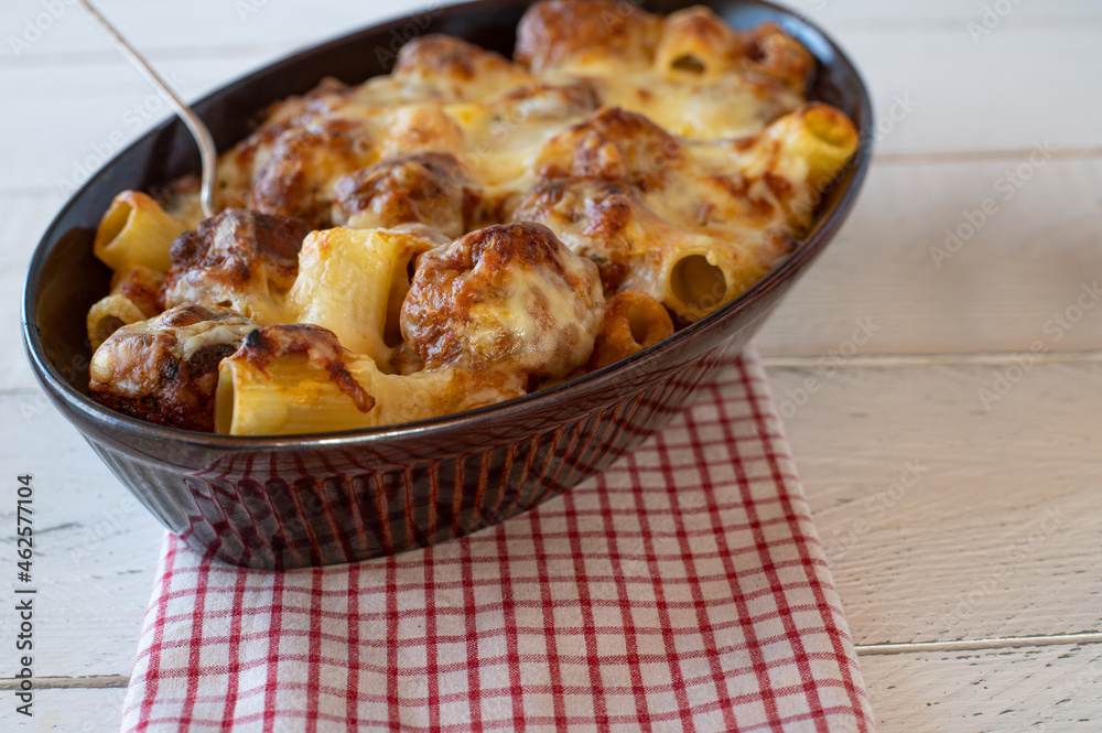 Casserole with italian meatballs, pasta, cheese and tomato sauce Casserole with italian meatballs, pasta, cheese and tomato sauce